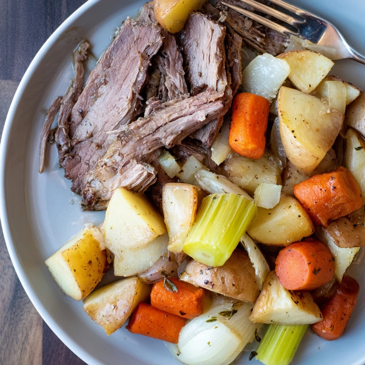 Tender Sunday Pot Roast surrounded by roasted veggies, perfect for cozy family dinners.  