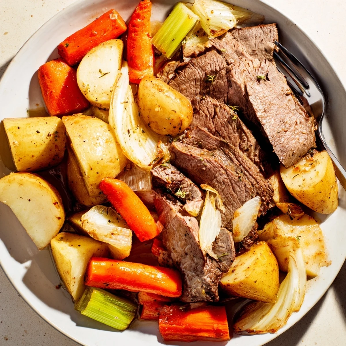 Slow-cooked Sunday Pot Roast with vibrant roasted carrots and potatoes, a hearty delight.  