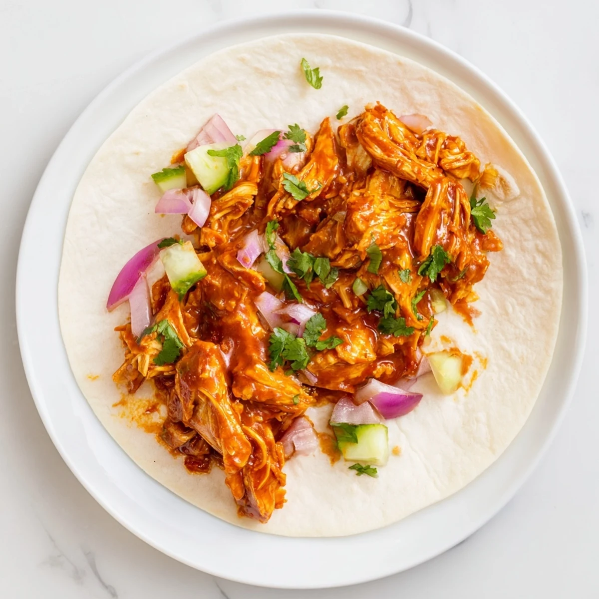 Tantalizing photo of sticky chicken tikka masala tacos served alongside fresh cilantro and lime wedges.