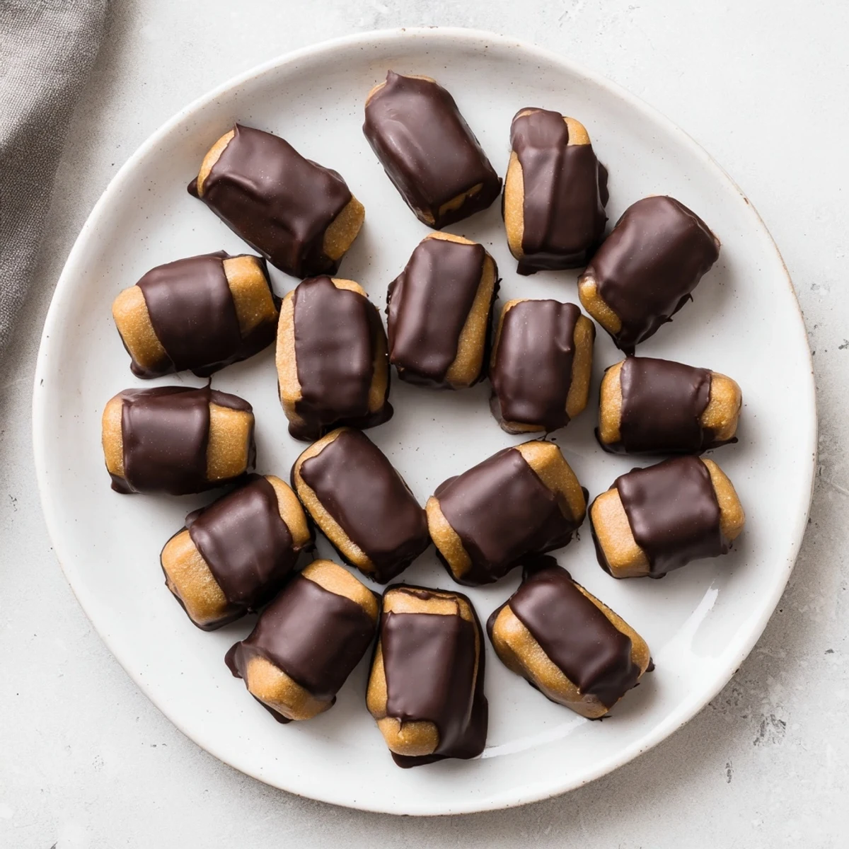 Homemade Peanut Butter Buckeyes are shown partially coated in chocolate, perfect for gift-giving and snacking.