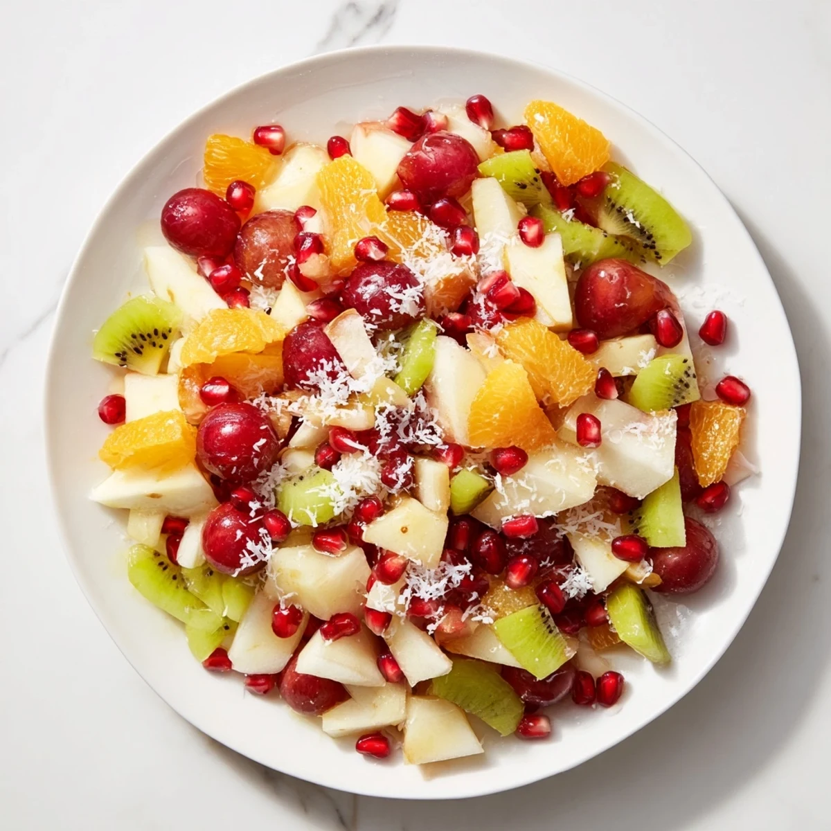 This festive Snowflake Fruit Medley features a dazzling display of winter fruits with snowy coconut.