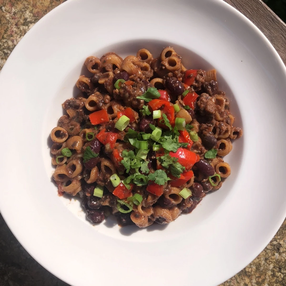 Rich, dark chili with ditalini pasta, featuring melted chocolate and robust spices for a flavorful main course.