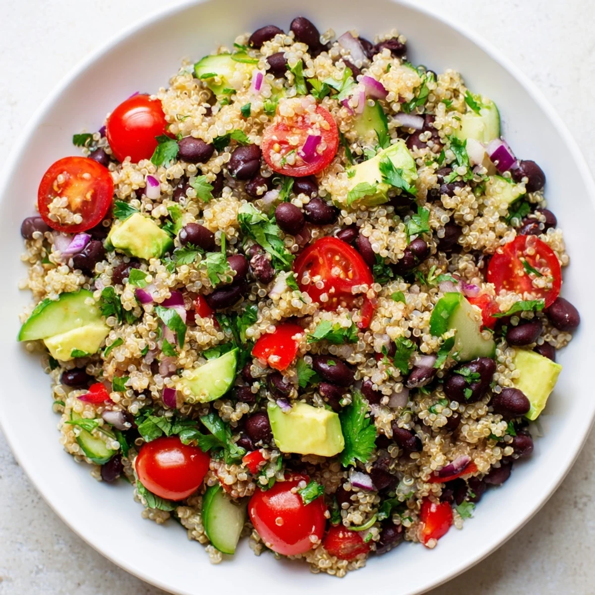 A refreshing Quinoa Black Bean Salad, full of colorful vegetables, looks delicious and healthy.