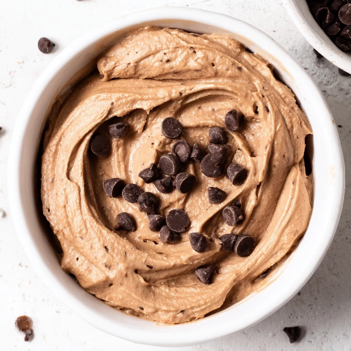 Creamy Brownie Batter Dip, swirled and ready to be scooped with fresh strawberries—a perfect dessert.
