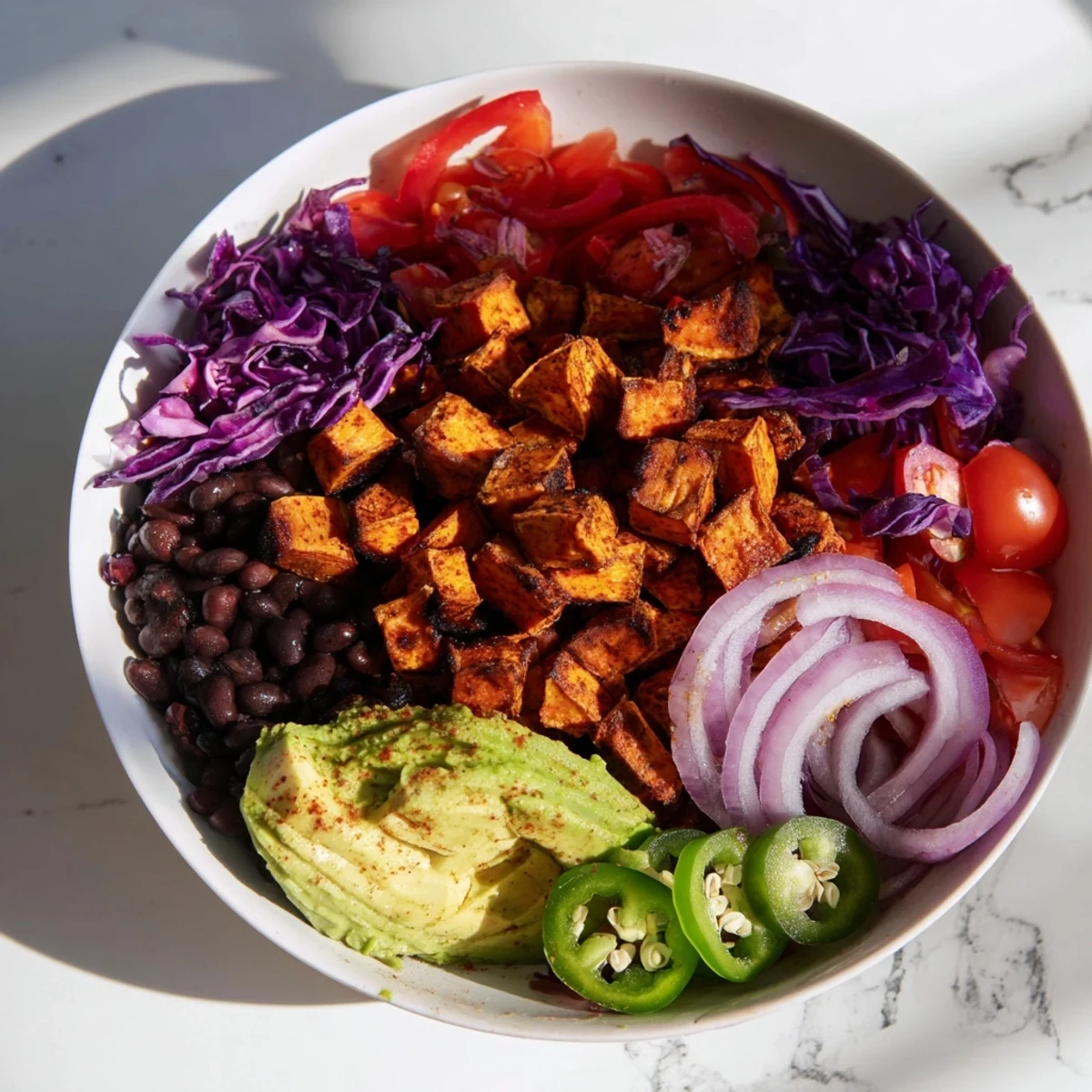 Golden-brown sweet potato taco bowls, overflowing with colorful veggies and creamy avocado, ready to be enjoyed.