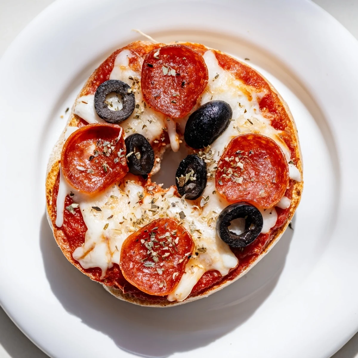 A close-up of cheesy mini bagel pizzas fresh from the air fryer, ready to be enjoyed.