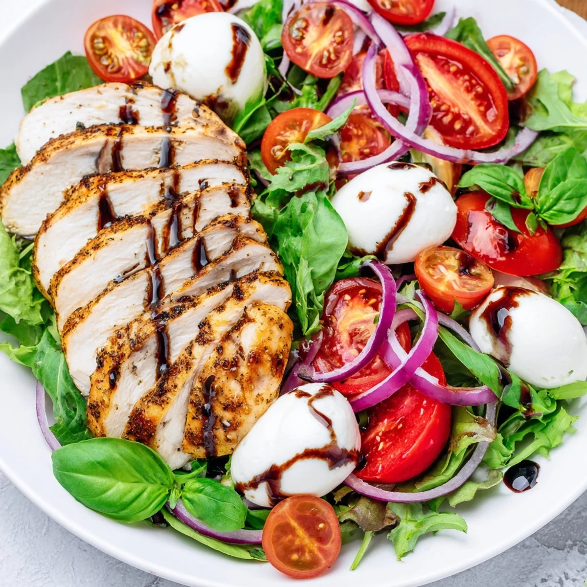 Enjoy this flavorful Caprese Chicken Salad, a refreshing main dish with balsamic drizzle.