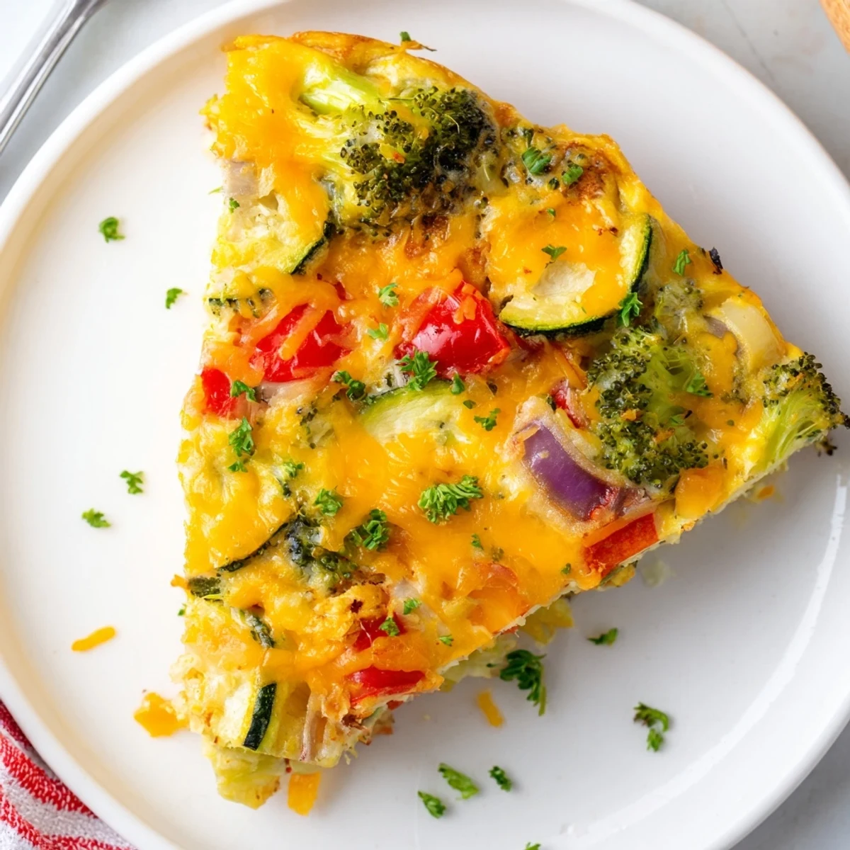 Freshly baked frittata with broccoli, peppers, and zucchini, ideal for a vegetarian meal.