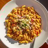 A close-up of a flavorful BBQ Rib Macaroni Skillet, promising a creamy, hearty bite.