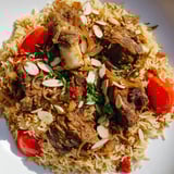 Rich, slow-cooked Qatari Majboos: showcasing savory lamb and fluffy rice infused with traditional spices.