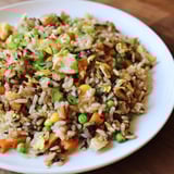 A delicious bowl of Black Garlic Fried Rice, served hot, glistening with sesame oil.