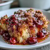 A golden, buttery cobbler topping crowns a bubbling cranberry filling in this festive holiday dessert.