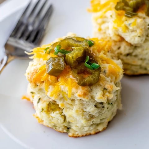 Fluffy Buffalo Ranch Dill Pickle Biscuit Muffins topped with creamy ranch and tangy flavor.  