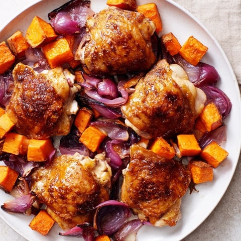 Golden, glistening Maple Glazed Chicken & Sweet Potato Bake with roasted vegetables, perfect for a weeknight dinner.