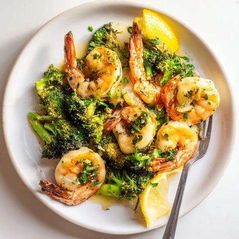 Golden, pan-seared lemon butter shrimp & broccoli with vibrant green broccoli florets, ready to enjoy.