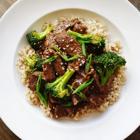 Tender slow-cooker Beef & Broccoli: A tempting, saucy dish served over fluffy brown rice.