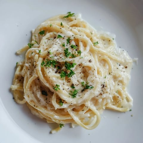 Creamy Three-Cheese Spaghetti, a comforting pasta dish, coated in a luscious cheese sauce.