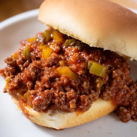 Steaming, savory Sloppy Joes piled high on toasted buns, dripping with a delicious tomato sauce.
