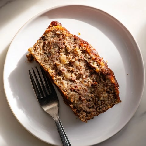 Golden-brown Effortless Stove Top Stuffing Meatloaf, ready to slice, offering savory, homemade flavors.