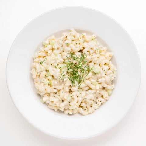 Golden, bubbly Pickle Mac and Cheese, with a generous sprinkle of fresh dill ready to serve.