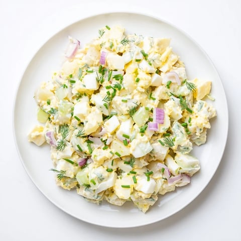 A vibrant photo of Chopped Egg and Potato Salad, featuring creamy potatoes and seasoned eggs.