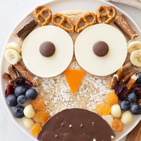 A colorful Owl Hooting Dessert Board with chocolate, cookies, and fruit—perfect for sharing!
