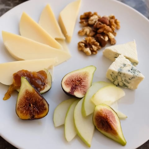 A beautiful Wine & Food Pairing Platter offers an array of cheeses, meats, and fruits for tasting.