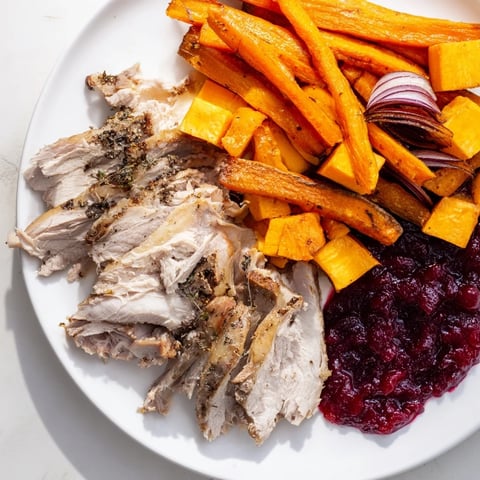 A beautifully arranged Harvest Turkey Platter featuring juicy sliced turkey and roasted seasonal vegetables.