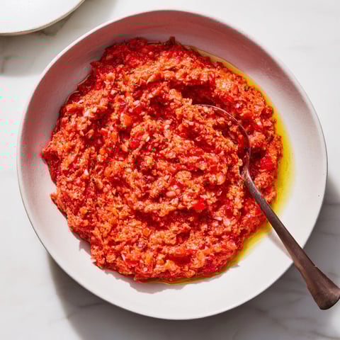 Volcanic Lava Spicy Dip swirled in a serving bowl, showcasing vibrant roasted peppers and a creamy, delicious texture.
