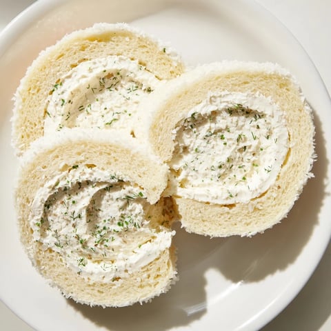 Elegant Snowball Tea Sandwich Bites, coated in coconut flakes, ready to serve for snack time.