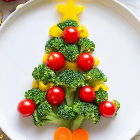 Vibrant Broccoli Tree with bright red cherry tomato "ornaments," a healthy holiday appetizer.
