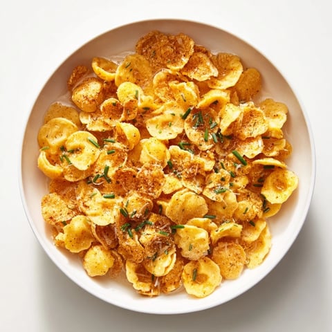 Crispy baked pasta chip cereal served in a warm parmesan broth, a whimsical snack.
