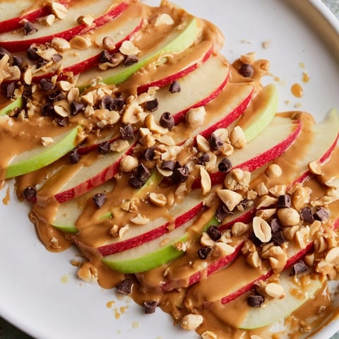 Crisp apple slices covered in peanut butter, a delightful Peanut Butter Apple Nachos snack.
