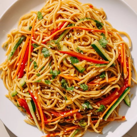 Vibrant Garlic Noodle Salad with colorful vegetables, coated in a savory sauce, ready to be enjoyed.