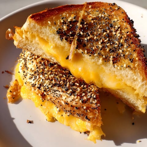 Everything Bagel Grilled Cheese with melted cheddar oozing out, perfect for lunch.