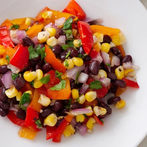 A colorful bowl of fresh Southwest Black Bean Salad, a light and healthy meal option.