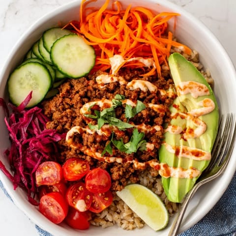 Delicious vegan plant-based meat bowl garnished with lime and vibrant veggies.  