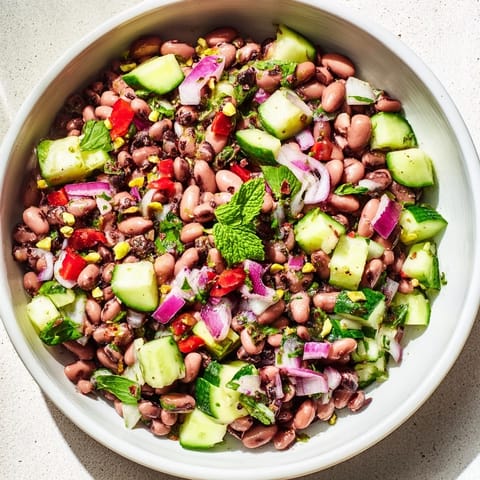Close-up of a vibrant, gluten-free Dense Bean Salad with Dubai Chocolate Notes, showcasing colorful ingredients.
