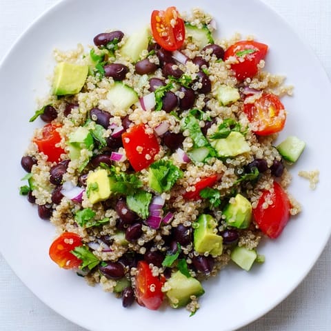 Vibrant Quinoa Black Bean Salad with diced avocado, perfect for a flavorful vegetarian lunch.