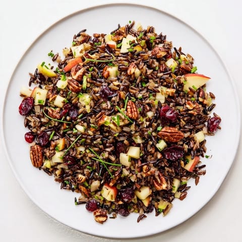 Hearty Wild Rice Harvest Salad, featuring plump cranberries and a flavorful vinaigrette, perfect for autumn.