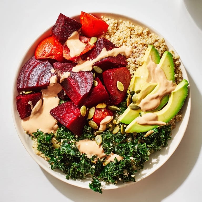 A visually appealing Quinoa, Kale & Roasted Beet Bowl featuring colorful roasted beets and creamy tahini dressing.