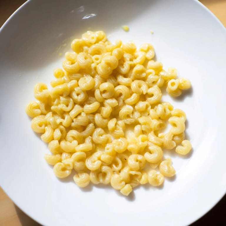 A close-up of steaming ditalini, glistening with butter and garlic, ready to be enjoyed.