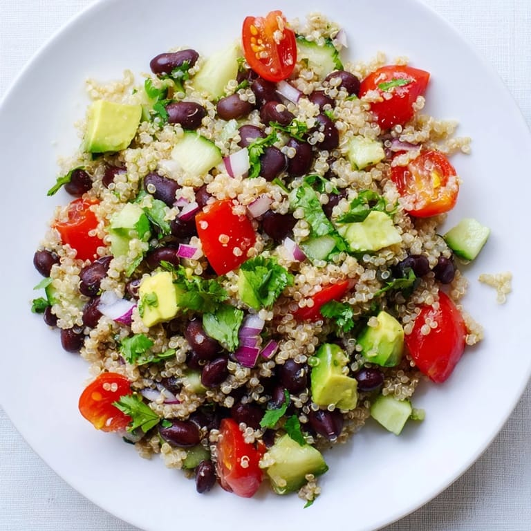 Vibrant Quinoa Black Bean Salad with diced avocado, perfect for a flavorful vegetarian lunch.