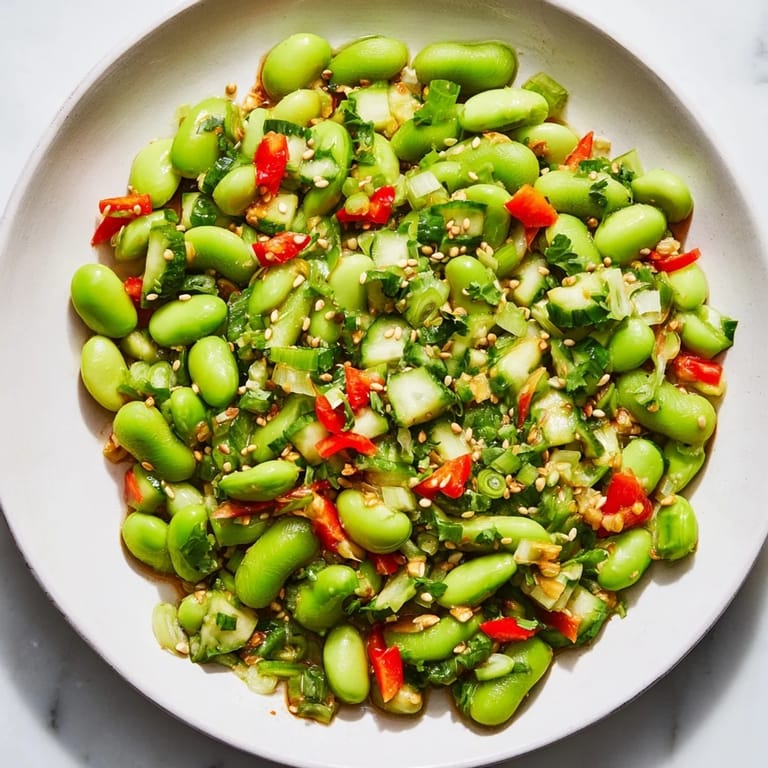 Chilled edamame salad tossed with crunchy vegetables, drizzled with savory dressing; enjoy this!