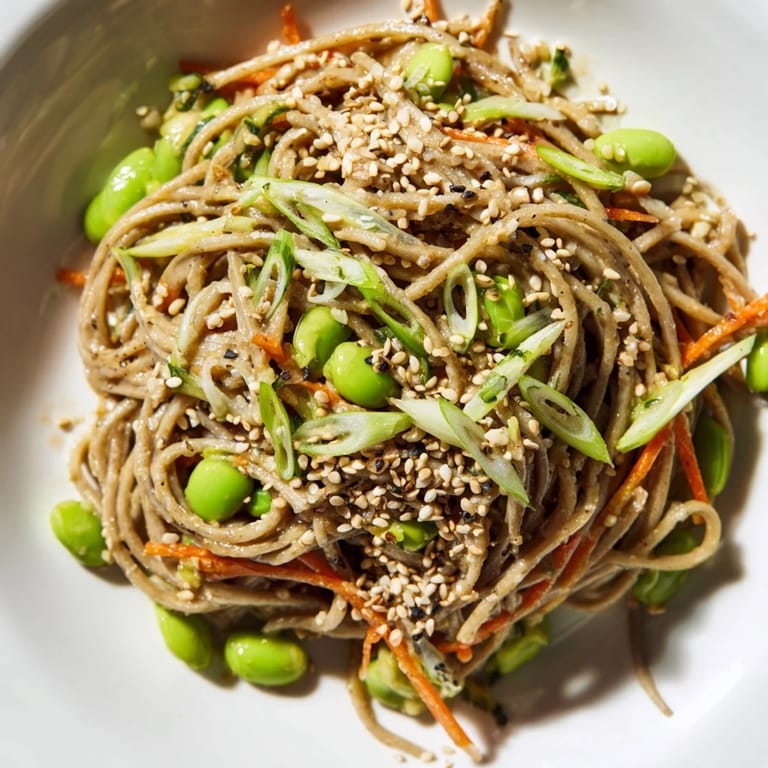 Close-up of the flavorful Asian Sesame Noodle Salad, ready to eat with a sprinkle of scallions.