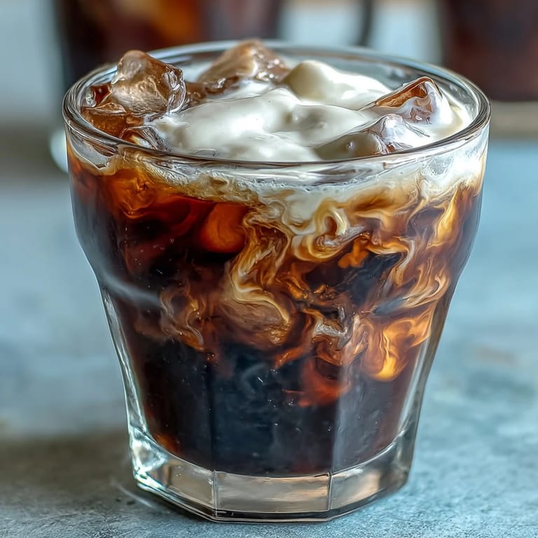 Refreshing iced cold brew coffee crowned with drizzled vanilla sweet cream.