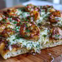Golden Garlic Butter Shrimp Naan Pizzas fresh from the broiler, with bubbly mozzarella and a garnish of fresh parsley.