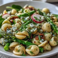 Vibrant spring pasta salad with lemon vinaigrette, crisp radishes, and fresh asparagus—ideal for picnics and light lunches.