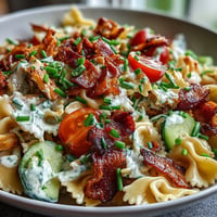 Creamy Chicken Bacon Ranch Pasta Salad with vibrant veggies and savory bacon.