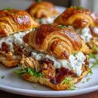 Golden brown chicken bacon ranch croissant sliders generously filled and ready to serve warm.